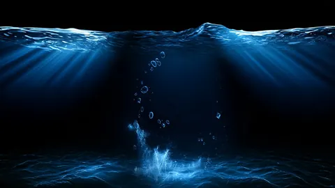 Light shafts pour down through the surface of a dark sea, with bubbles rising toward the waves.