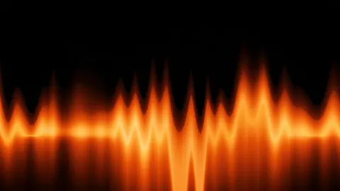 A row of amber peaks rises and falls like a glowing sound wave over a dark floor.