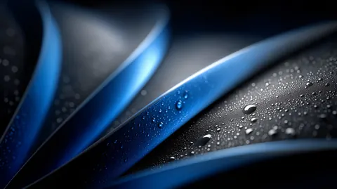 Curved blue and silver blades overlap in close-up, dotted with fine beads of water.