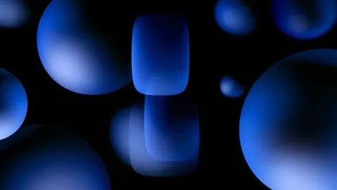 Glossy cobalt spheres and rounded shapes float at different depths against black.