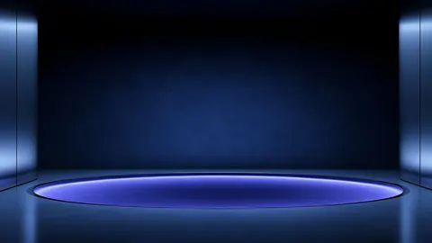 A blue oval ring glows on the floor of a wide hall between tall lit pillars.