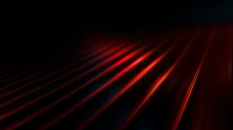 Parallel red light ridges fan across a black floor, fading into the distance.