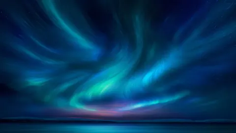 Teal and blue aurora ribbons sweep across a dark horizon.