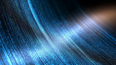 Countless fine blue fibers curve through the frame, with a warm glow breaking in from the top corner.