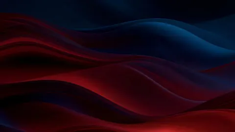 Smooth layers of deep red and dark teal roll across the frame like dunes made of glass.