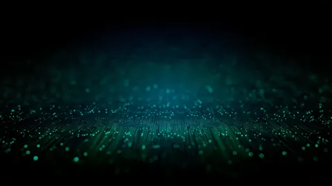 A dense field of glowing green and cyan particles floats against darkness.
