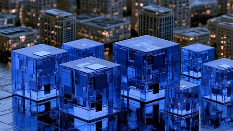 Translucent blue glass cubes stand in front of a city of lit buildings.