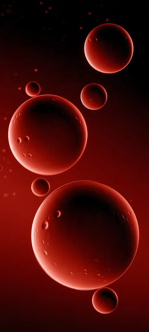 Glowing garnet spheres drift through soft red haze on a dark field, some sharp and some lost in the blur.