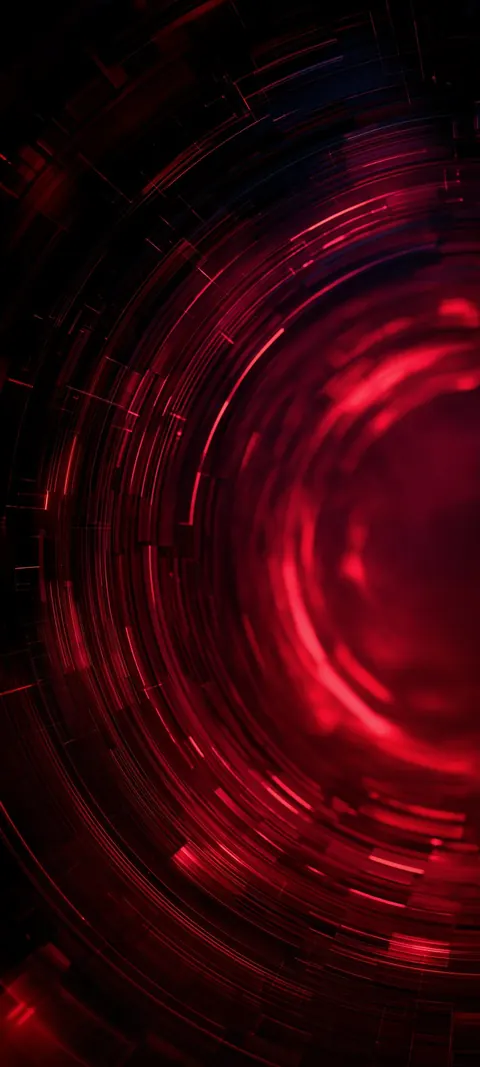 A ruby-red vortex spins into a bright core, with dark outer rings that leave the top of the frame quiet.